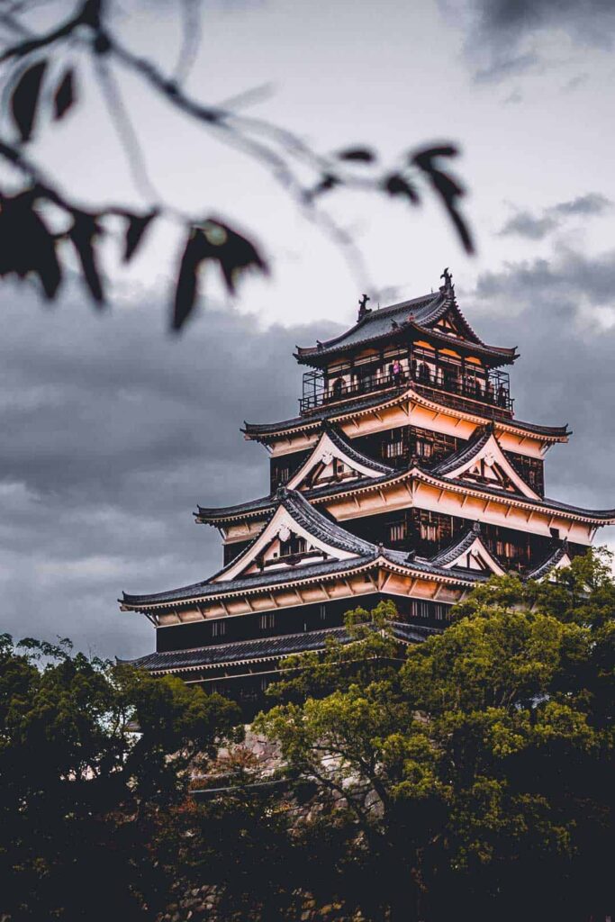 Hiroshima castle with dark clouds looming behind it.